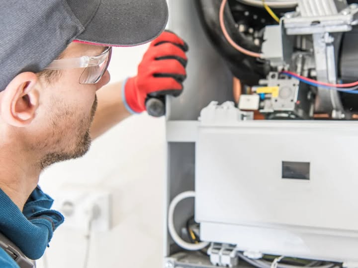 Plumber performing preventive maintenance on bathroom plumbing system